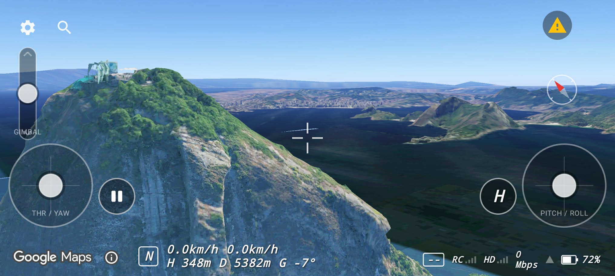 Flying past a green mountain ridge with the goggle-style OSD
